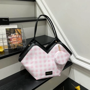 Pink checkered V-neck tote bag with black trim and matching mini pouch on a black stand