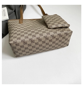 Detail view of jacquard tote bag set with matching pouch and brown leather trim