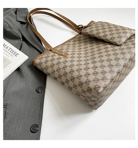 Flat lay of large tote bag with matching pouch on white background with blazer