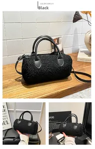 Detail of black faux fur boston bag with leather handles on a minimalist wooden table