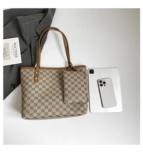 Detail of printed tote bag set with geometric pattern showing tablet for size reference
