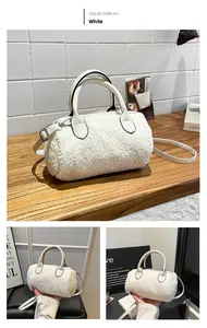 Close-up of a white faux fur barrel bag with leather straps and metal hardware detail