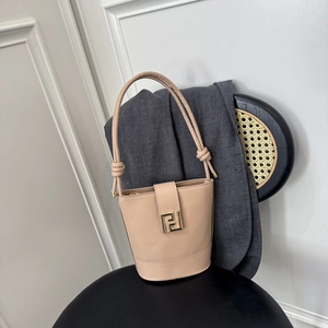 Minimalist apricot leather bucket bag with gold square metal buckle and knotted strap detail
