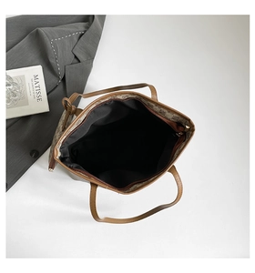 Top view of large brown plaid tote bag showing zip closure and spacious black interior