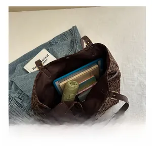 Detailed interior of leopard print tote bag showing spacious storage for tablet and umbrella