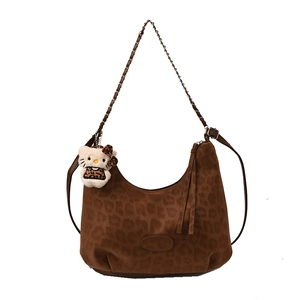 Leopard print hobo bag with gold chain strap and plush kitten charm accessory