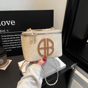 Elegant beige crossbody box bag with gold chain strap and brown circular logo detail