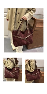 Detail of red-brown leopard print tote bag with leather cross straps and metal buckle