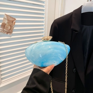 Blue and white marble acrylic oval clutch bag with gold chain and egg-shaped clasp