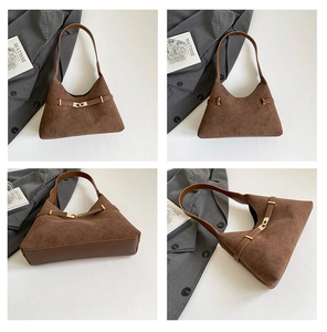 Detail view of a vintage dark brown suede dumpling bag with elegant gold buckle hardware