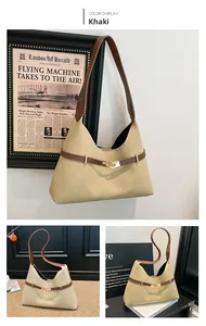 Detail of khaki suede dumpling bag with brown leather strap and golden buckle accent