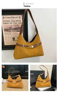 Detail view of the yellow suede tote bag with brown leather straps and buckle