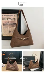 Detail view of coffee-colored suede tote bag featuring premium metal buckle and strap