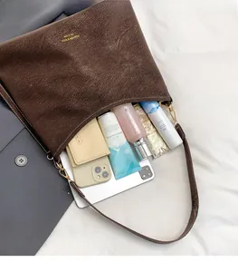 Top view of dark brown vintage tote showing storage capacity for tablet and cosmetics