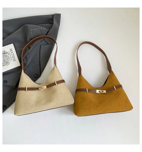 Detail view of triangular tote bags in cream and yellow with leather texture