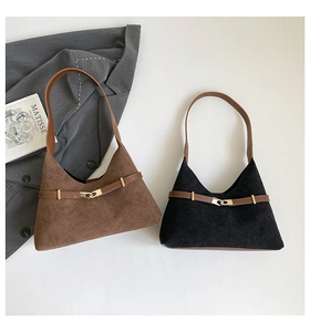 Detail of vintage suede tote bags in black and brown with elegant gold metal buckles