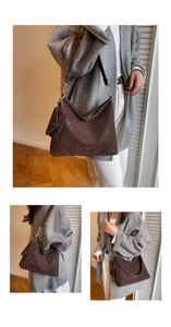 Detail of a dark brown vintage hobo bag with gold hardware and small hanging pouch