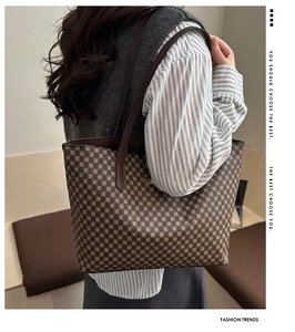 Detailed side view of large capacity tote bag with geometric pattern and dark handles