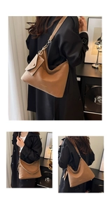 Detail of vintage brown leather tote bag with a small matching pouch and gold lettering