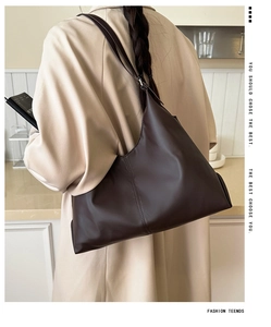 Detail view of large dark brown hobo shoulder bag with reinforced stitching and soft PU leather