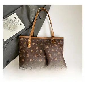 Detail of coffee brown tote bag with repeating pattern and matching small coin purse
