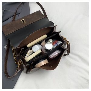 Detail view of the vintage brown crossbody bag interior with multiple compartments and gold lock