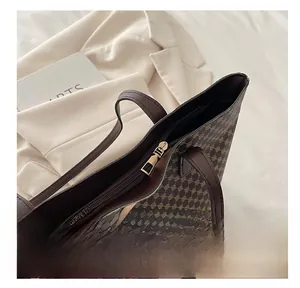 Detail of smooth gold zipper on vintage checkerboard print tote bag for women
