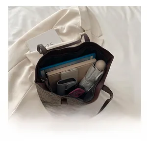 Macro view of checkered tote bag interior showing spacious capacity for tablets and essentials