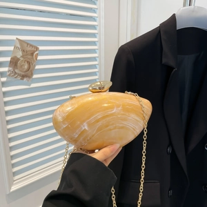 Shell-shaped yellow acrylic evening bag with marble texture and golden chain