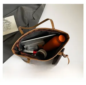 Top view of spacious brown monogram tote bag interior showing large capacity for essentials