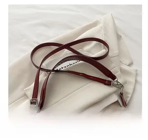 Macro shot of comfortable burgundy leather shoulder strap with silver swivel hook