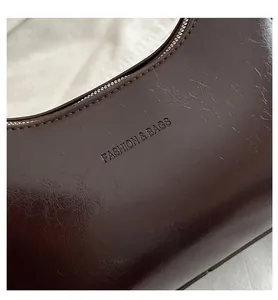 Close-up of dark brown leather texture with Fashion & Bags embossed lettering