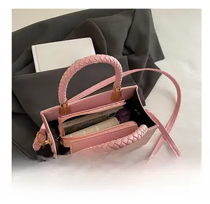 Top view of pink leather tote bag showing spacious interior with wallet and smartphone