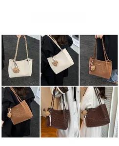 Detail view of leopard print tote bags with woven straps and cute plush bear charm