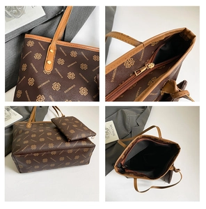 Detail of dark brown tote set with clover pattern, gold zipper and interior storage space