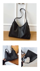 Detail view of large black tote bag featuring smooth leather texture and minimalist design