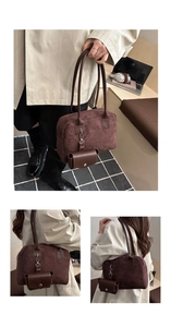 Detail view of dark brown suede bowling bag with detachable coin purse and twin handles