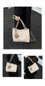 Detail of cream tote bag featuring leopard embossing, braided handle and plush bear charm