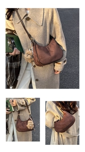 Detail of dark brown suede crescent bag with leather trim and teddy bear charm