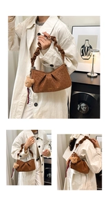 Detail of brown leopard print underarm bag with pleated strap and teddy bear charm