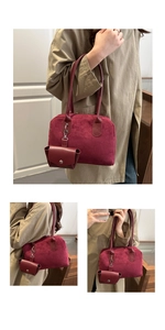 Detail of burgundy crossbody bag with matte suede texture and smooth leather handle