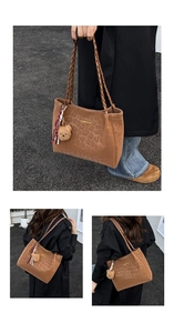 Detail of leopard print tote bag with Creative Cat text and plush bear charm accessory