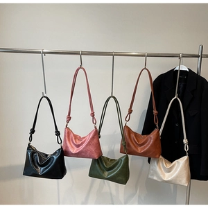 Detailed display of five colorful vintage leather hobo bags with knot straps for daily wear