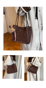 Detail of leopard print tote bag with woven strap, plush charm and Creative Cat text
