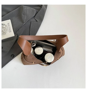Spacious interior of brown suede tote bag showing storage for phone and cosmetics