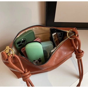 Spacious interior of caramel brown hobo bag with zip pocket and gold hardware detail