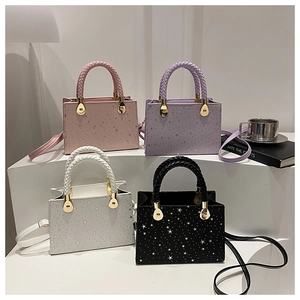 Detail showing high-quality star pattern texture and woven handles on mini square bags