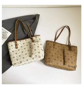 Detail of clover patterned tote bags with matching pouches and brown contrast handles