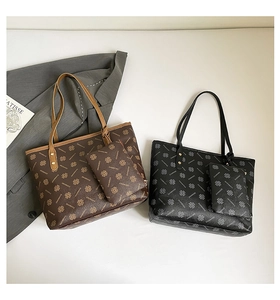 Detail of vintage tote bag set with clover print and matching pouch in coffee and black
