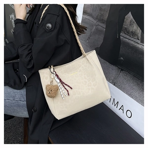 Beige leopard tote bag with Creative Cat gold logo and woven shoulder strap